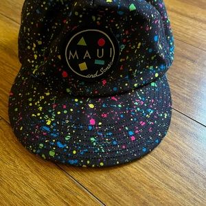 Fun hat neon splattered black background